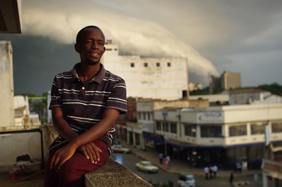 CLEAR Kisumu Communications Intern Dennis outside the CLEAR Office