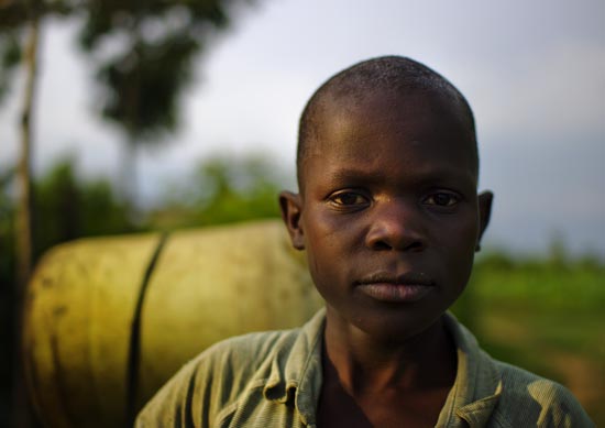 Child Carrying Water in Ukwala, where CLEAR is discussing with Local chiefs about community legal awareness programs